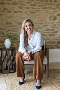 woman sitting in chair stone wall